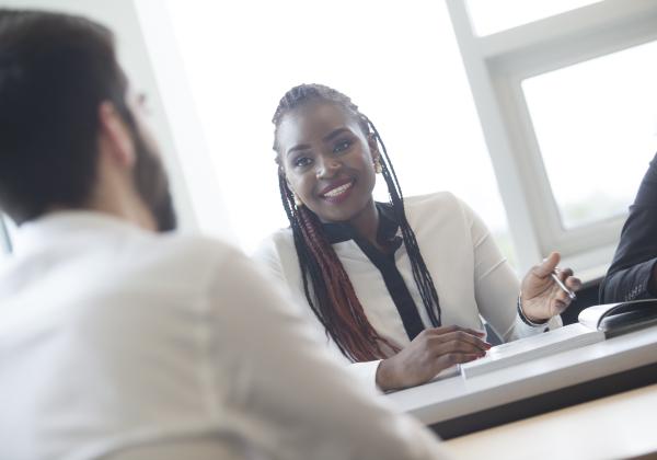 A female and a male student sitting together talking