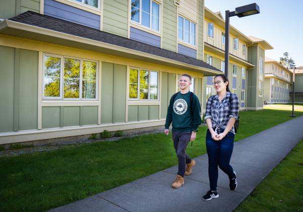 Two Students walk by the VIU Residence