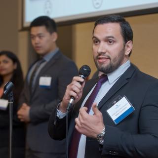 Three MBA internship students presenting their PechaKucha at the 2019 Business Mixer at the Coast Bastion Hotel