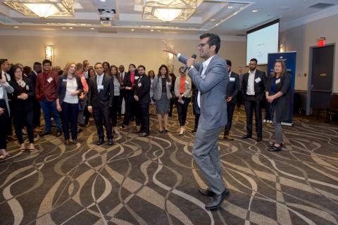 Attendees listening to a student speak at the 2019 Business Mixer at the Coast Bastion Hotel