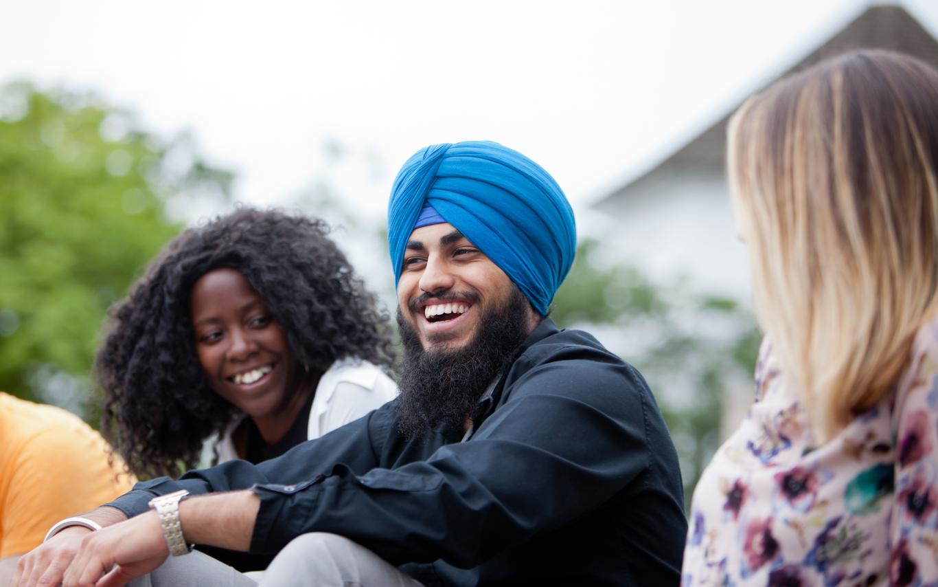 3 Students Sitting and Laughing